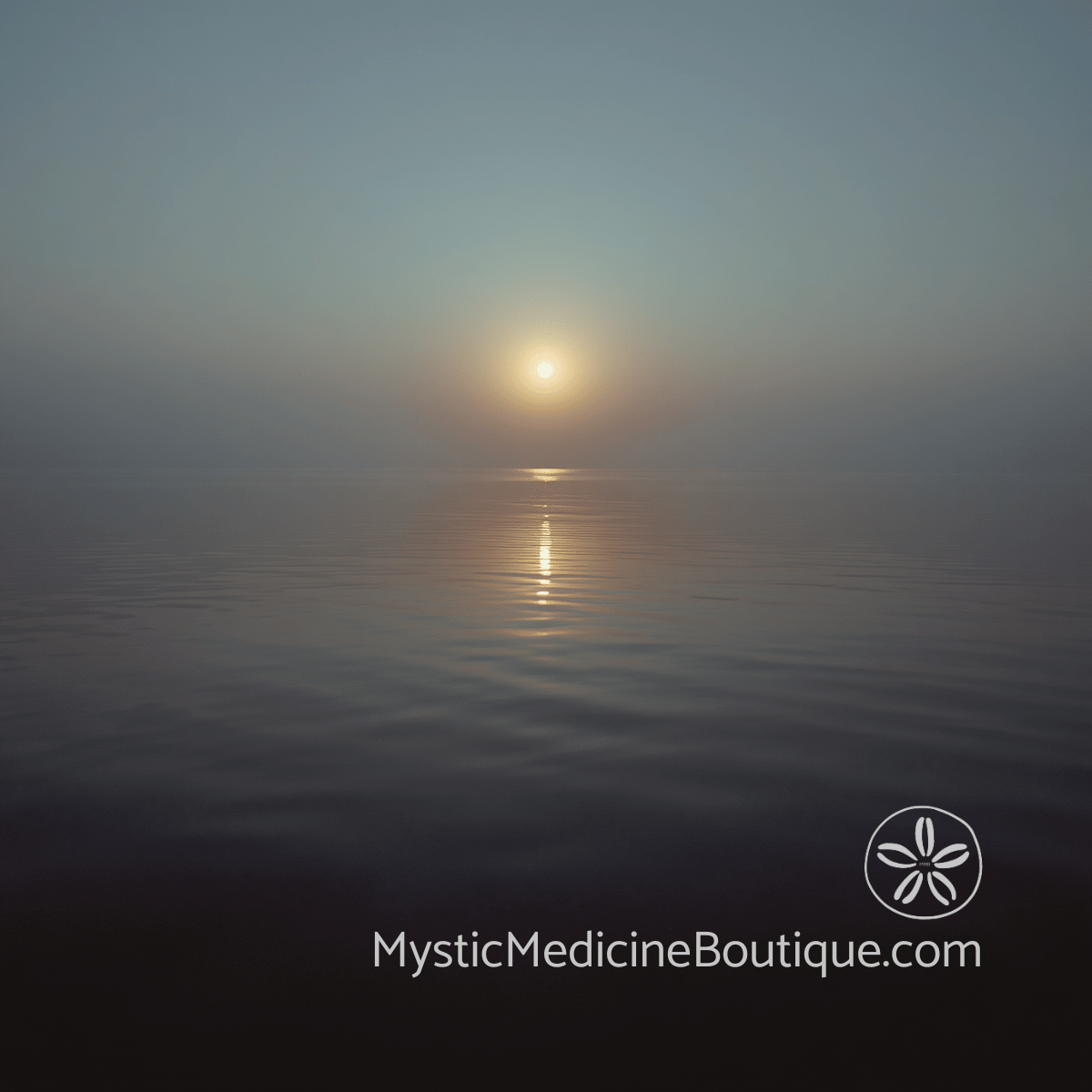 Calm ocean at dawn with a soft golden light reflecting on still water