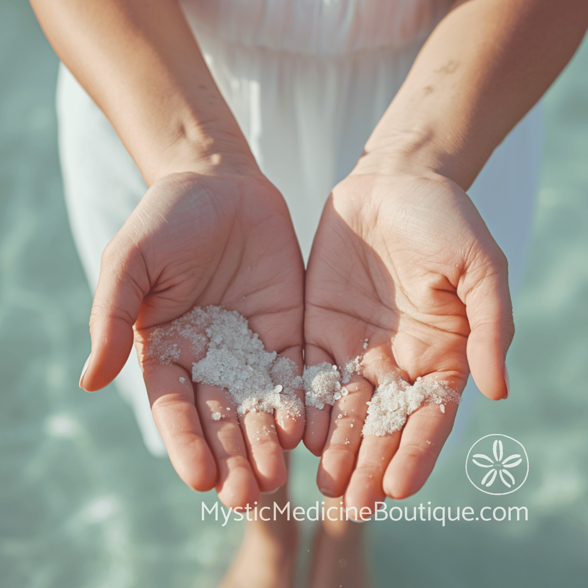 Hands releasing sand at a tropical shoreline, representing the spiritual meaning of dropping things as a sign of energetic release or realignment