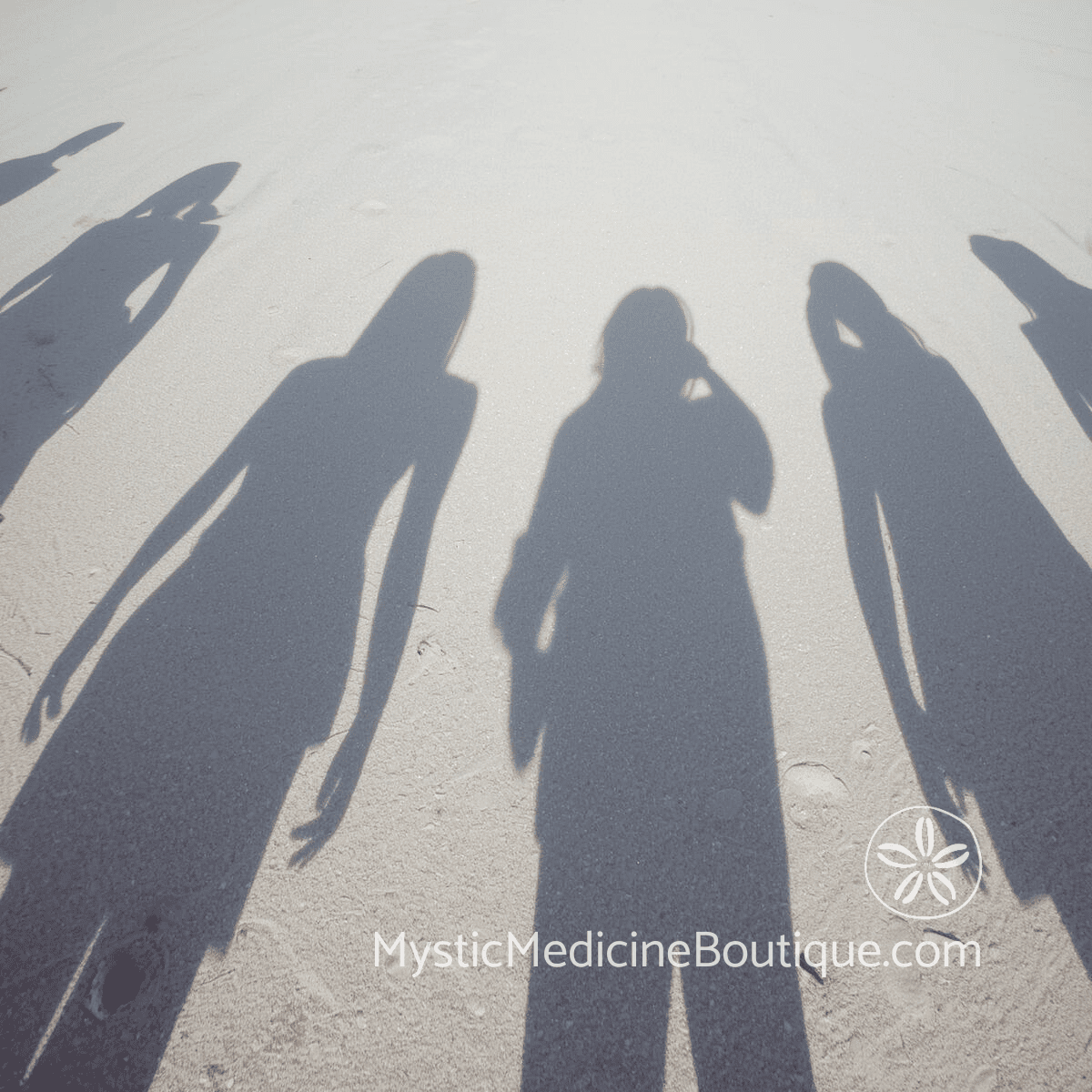 Group of human shadows on sand representing the compound devastation of betrayal by multiple people