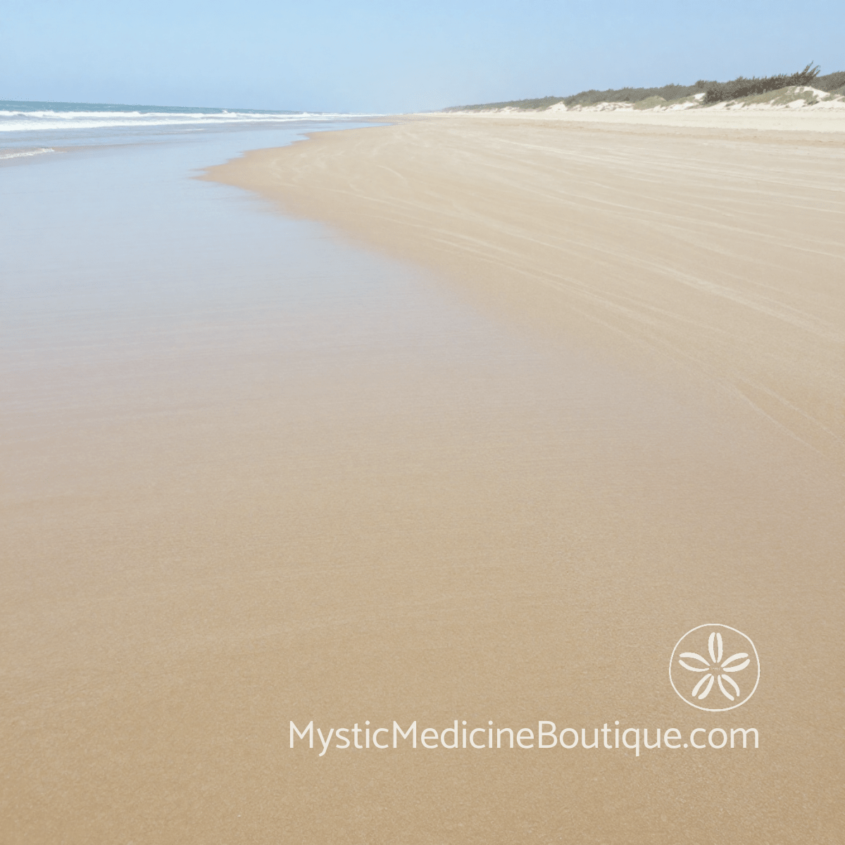 Vast empty tropical beach with calm water line representing how to overcome spiritual burnout and rebuild your energy from depletion — Mystic Medicine Boutique