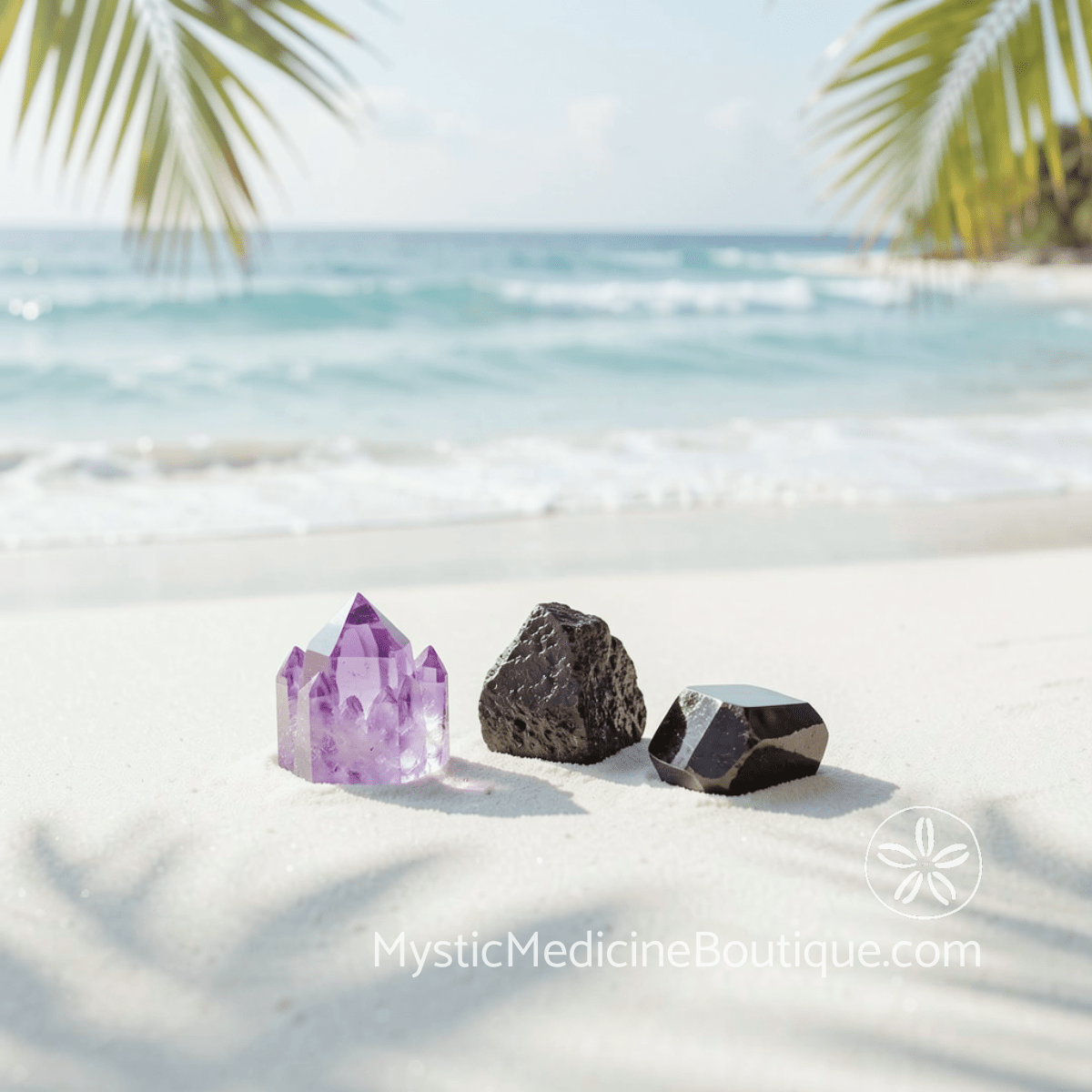 Amethyst obsidian and black tourmaline crystals on tropical beach sand, crystal support for shadow work spiritual emergency