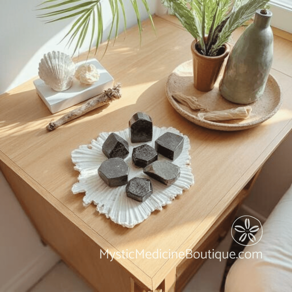 Grounding crystals including black tourmaline for kundalini emergency first aid on wooden tray